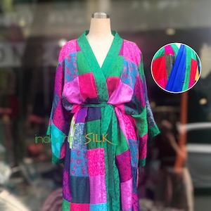May include: A long, colorful silk robe with a patchwork design in shades of pink, green, blue, and purple. The robe has a sash tie at the waist and is made of a soft, luxurious fabric.