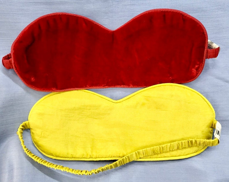 May include: Two sleep masks, one red velvet and one yellow silk.