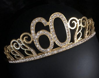 May include: Gold-colored tiara with rhinestones, featuring the number "60" in the center.