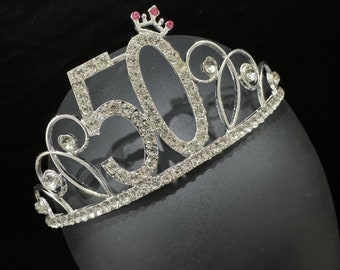 May include: Silver tiara with rhinestones and a pink crown on top. The tiara has the number 50 in rhinestones.