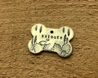 Jurassic Jungle Hand Stamped Metal Pet ID Tag | Bone Shaped Custom Name Tag | Dinosaur Themed Brontosaurus T-Rex Nametag for Cats Dogs