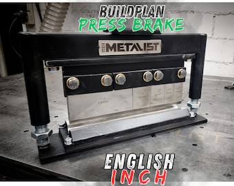 May include: A black metal press brake with a silver metal blade. The blade has markings for different bend depths in inches. The press brake is labeled "BUILDPLAN PRESS BRAKE" and "THE METALIST".