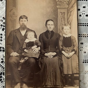 Cabinet card of a serious Victorian family with two children
