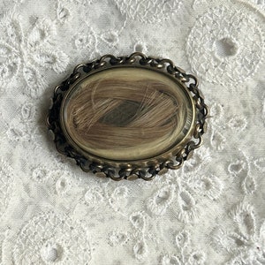 Mourning hair brooch with blonde hair and engraved name on the back