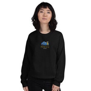 May include: Black sweatshirt with a graphic of a mountain range and a UFO with the text "PATIENCE Colorado" in gold lettering.