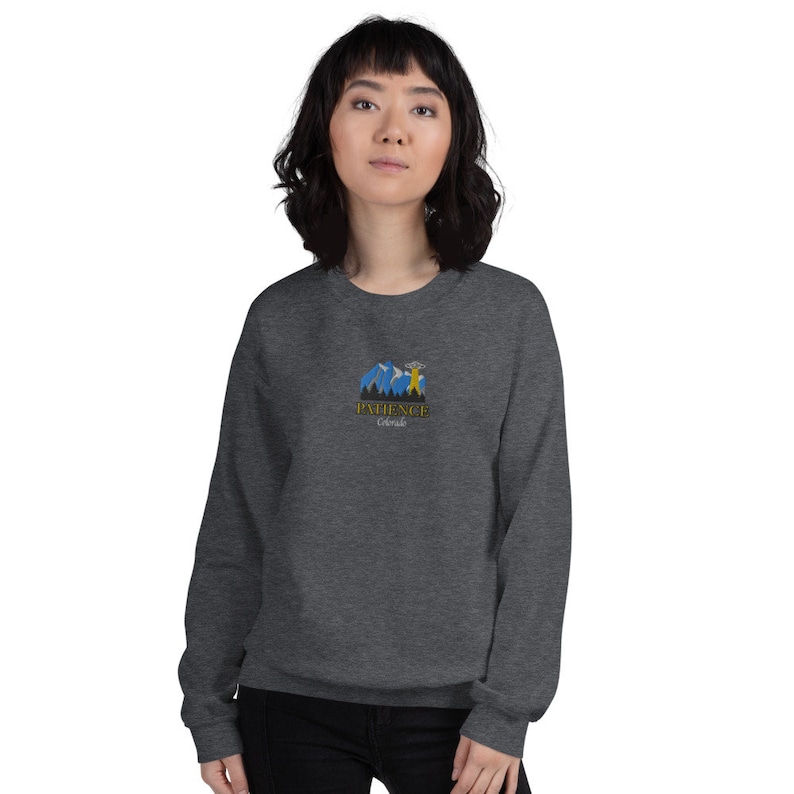 May include: A dark gray sweatshirt with a graphic of a mountain range and the text "PATIENCE Colorado" in yellow and blue.