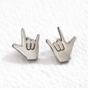 Silver coloured sign language stud earrings I love you hand gesture flat lay