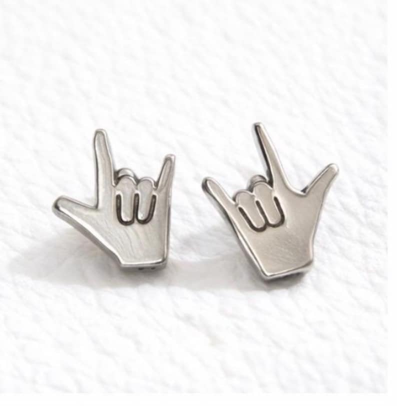 Silver coloured sign language stud earrings I love you hand gesture flat lay