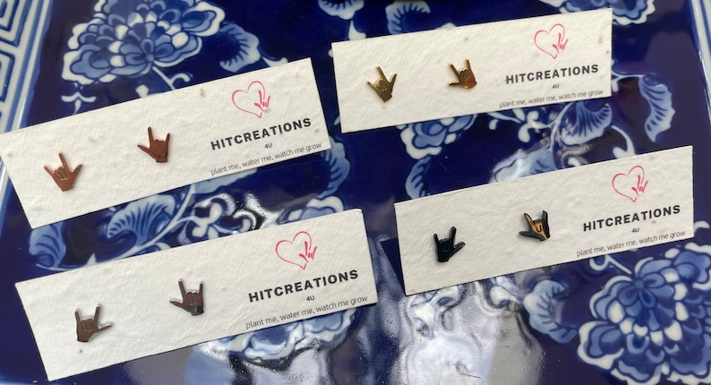 stainless steel earrings in the i love you handshape