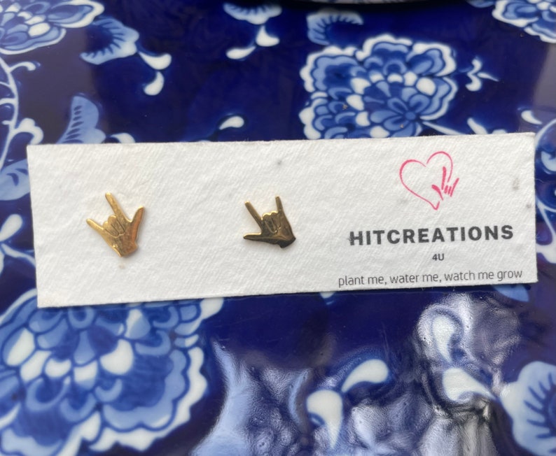 stainless steel earrings in the i love you handshape