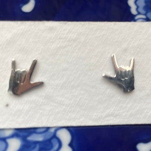 stainless steel earrings in the i love you handshape