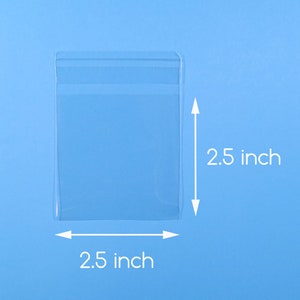 May include: A clear plastic bag with a sealed opening, measuring 2.5 inches by 2.5 inches.