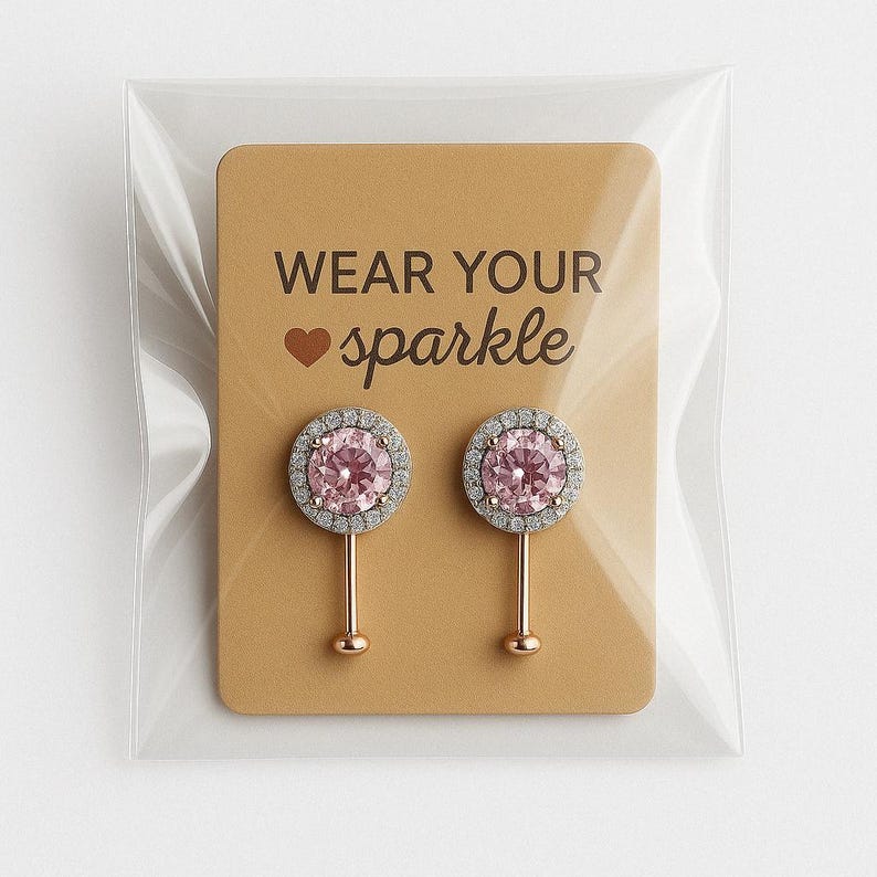 May include: A pair of pink and silver earrings with a clear plastic packaging and a card that says "Wear your sparkle" with a heart symbol.