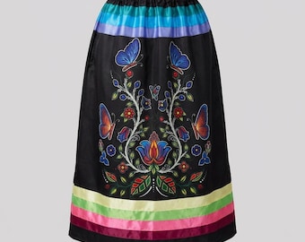 May include: A black skirt featuring an elastic waistband and a colourful floral and butterfly print in shades of blue, red, and green. The hem is decorated with horizontal stripes in light green, yellow, pink, and dark red satin ribbon trim.