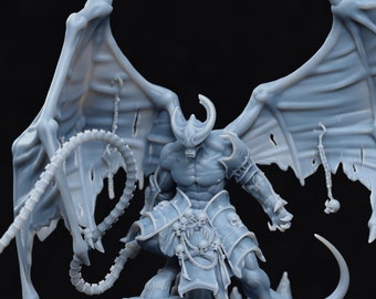 May include: A gray 3D printed miniature of a demon with large wings, a whip, and a skull-adorned belt. The demon is standing on a rocky base.