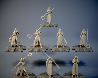 May include: Set of nine miniature figures of women in hooded robes, each holding a weapon, standing on circular bases. The figures are made of a light gray plastic and are posed in various fighting stances.