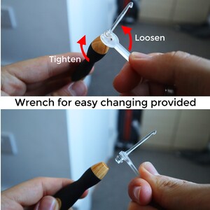 May include: A close-up of a wooden handled crochet hook with a clear plastic wrench. The wrench can be used to tighten or loosen the hook. The text "Tighten" and "Loosen" are shown with arrows indicating the direction to turn the wrench.