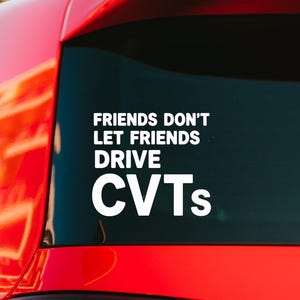 May include: A white vinyl decal applied to the rear window of a red vehicle. The decal features the text in a bold, sans-serif font that reads: FRIENDS DON'T LET FRIENDS DRIVE CVTs. The lettering is arranged in four lines against the dark glass.