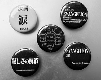 May include: Five black and white round buttons with different designs and text. The buttons feature the Japanese words "次回" and "涙", the text "SEBLE", the text "EVANGELION", and the text "寂しさの解消".