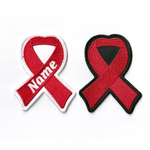 May include: Two red ribbon patches, one with a white outline and the word "Name" in white, the other with a black outline. Both are embroidered.