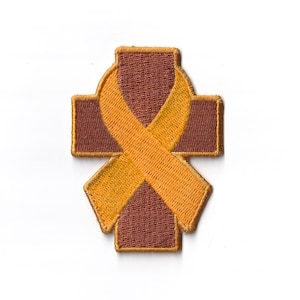 May include: A brown cross with a yellow ribbon in the center. The ribbon is tied in a bow.
