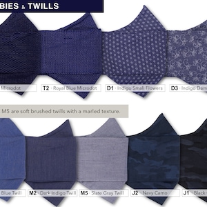 May include: A selection of face masks in various colors and patterns, including navy microdot, royal blue microdot, indigo small flowers, indigo damask floral, royal blue twill, dark indigo twill, slate gray twill, navy camo, and black camo. The text "DOBBIES & TWILLS" is at the top of the image. The text "M1, M2, M5 are soft brushed twills with a marled texture." is in the middle of the image. The text "T1 - Navy Microdot", "T2 - Royal Blue Microdot", "D1 - Indigo Small Flowers", "D3 - Indigo Damask Floral", "M1 - Royal Blue Twill", "M2 - Dark Indigo Twill", "M5 - Slate Gray Twill", "J2 - Navy Camo", and "J1 - Black Camo" is at the bottom of the image.