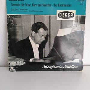 May include: A black and white photo of a man playing the piano. The photo is from a vinyl record cover. The text on the cover reads "Benjamin Britten Serenade für Tenor, Horn und Streicher - Les Illuminations Peter Pears Dennis Brain Neues Symphonie-Orchester EUGENE GOOSSENS DECCA TRUE HIGH FIDELITY LXT 2741 HI-FI Benjamin Britten"
