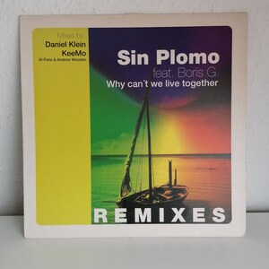 May include: A square album cover with a yellow and multi-colored design. The cover features the text "Sin Plomo feat. Boris G. Why can't we live together REMIXES". A sailboat is depicted on the cover.