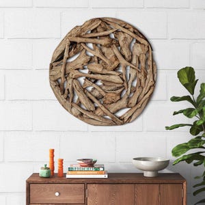 May include: A round wall decor made of natural driftwood branches arranged in a circular pattern. The driftwood is a light brown color and has a natural, rustic look.