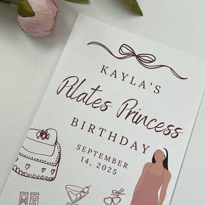 Puede incluir: Una tarjeta blanca con el texto "KAYLA'S Plates Princess BIRTHDAY SEPTEMBER 14, 2025" en escritura marr&oacute;n. La tarjeta tiene ilustraciones de una mochila, zapatillas de ballet, un martini, corazones, pesas y una mujer con ropa deportiva.