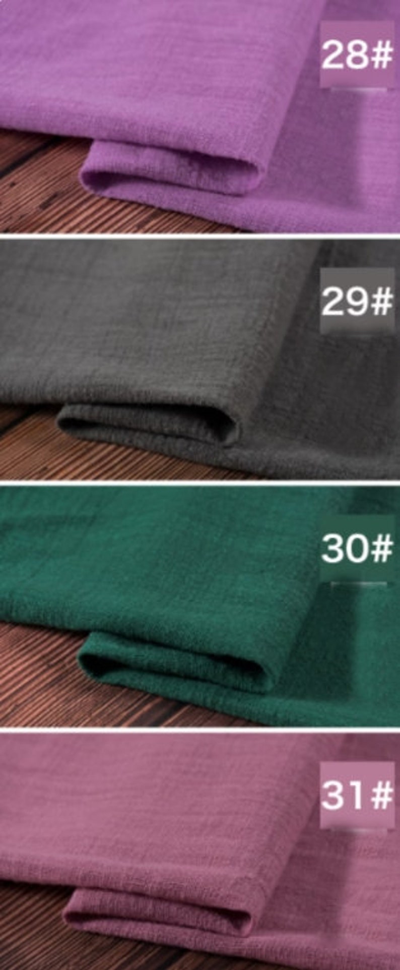 May include: Four fabric swatches in different colors: purple, gray, green, and pink. The swatches are folded and labeled with numbers 28, 29, 30, and 31.