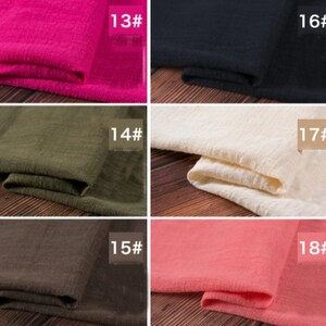 May include: Close-up of eight fabric swatches in different colors, including pink, black, beige, green, brown, and coral. Each swatch is labeled with a number, from 13 to 18.