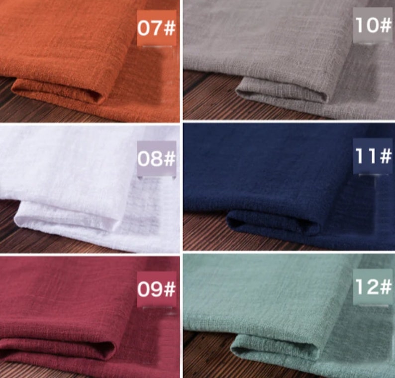 May include: A close-up of ten fabric swatches in different colors. The swatches are arranged in two rows of five. The colors are: orange, gray, white, navy blue, red, green, brown, black, beige, and light blue.