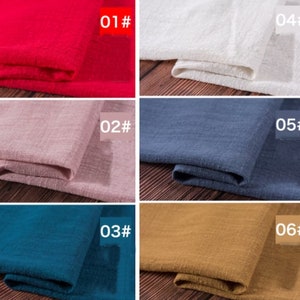 May include: Six fabric swatches in different colors, folded and displayed on a wooden surface. The swatches are labeled with numbers 01 through 06. The colors are red, pink, blue, teal, brown, and white.