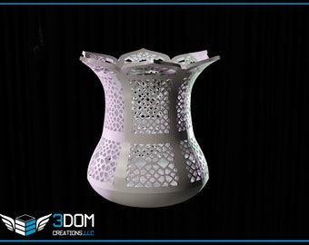 May include: A white, intricately designed, decorative vase with a geometric pattern. The vase has a wide mouth and a narrow base.