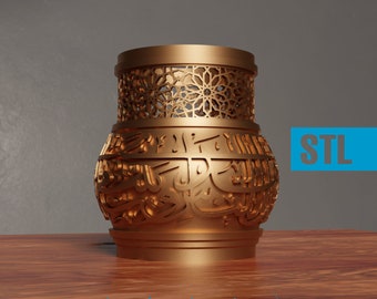 May include: A gold-colored decorative vase with intricate cut-out patterns and Arabic script. The upper section features a geometric design, while the lower section displays ornate calligraphy. The word "STL" is in a blue rectangle.
