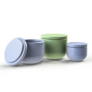 May include: Three ceramic containers with lids. One container is green and the other two are blue.