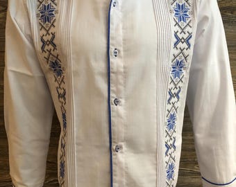 May include: White long-sleeve button-up shirt with blue trim and embroidered snowflake designs.