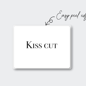 May include: A white rectangular sticker with rounded corners, featuring the text "Kiss CUT" in a bold, black font. The words "Easy peel edges" are written in cursive with an arrow pointing to the sticker.