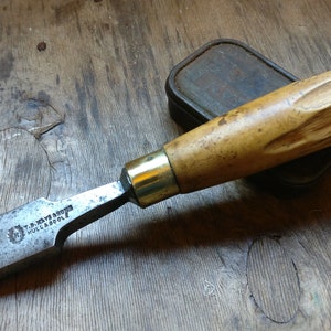 May include: A vintage wood handled chisel with a brass ferrule and a steel blade. The blade is marked "J. & W.  RAYNOR  HOLBROOK".