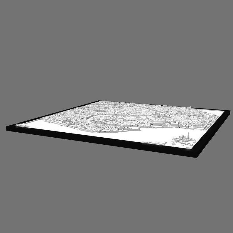 Op de afbeelding: Een wit 3D-model van een stad in een zwart frame. Het model is gedetailleerd en toont de lay-out van de stad.