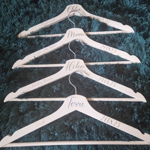 White Personalised wooden coat hanger perfect for weddings can be bought as a single or a set.