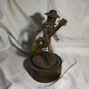 Spring man singing with guitar music trinket