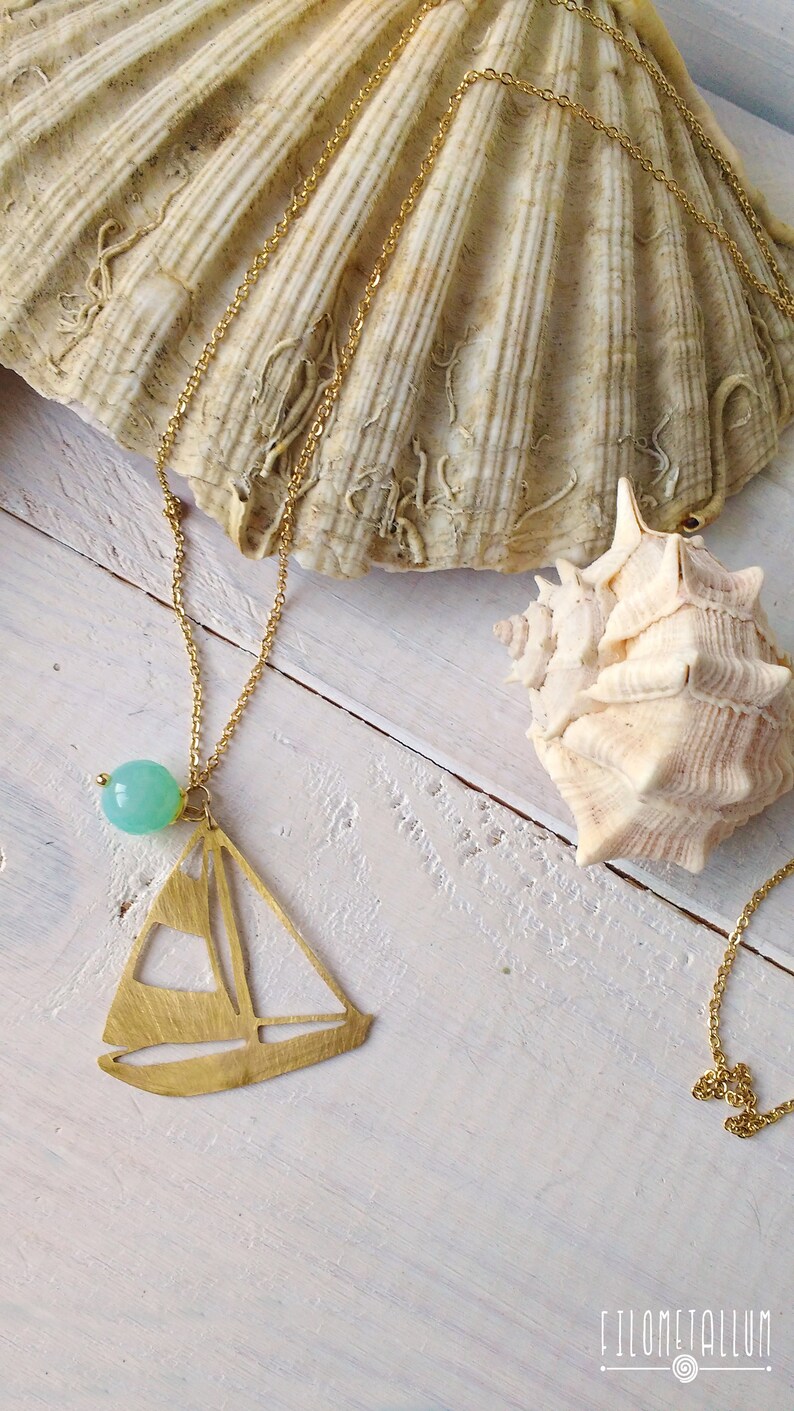 long necklace with steel chain and brass pendant in the shape of a sailboat handmade