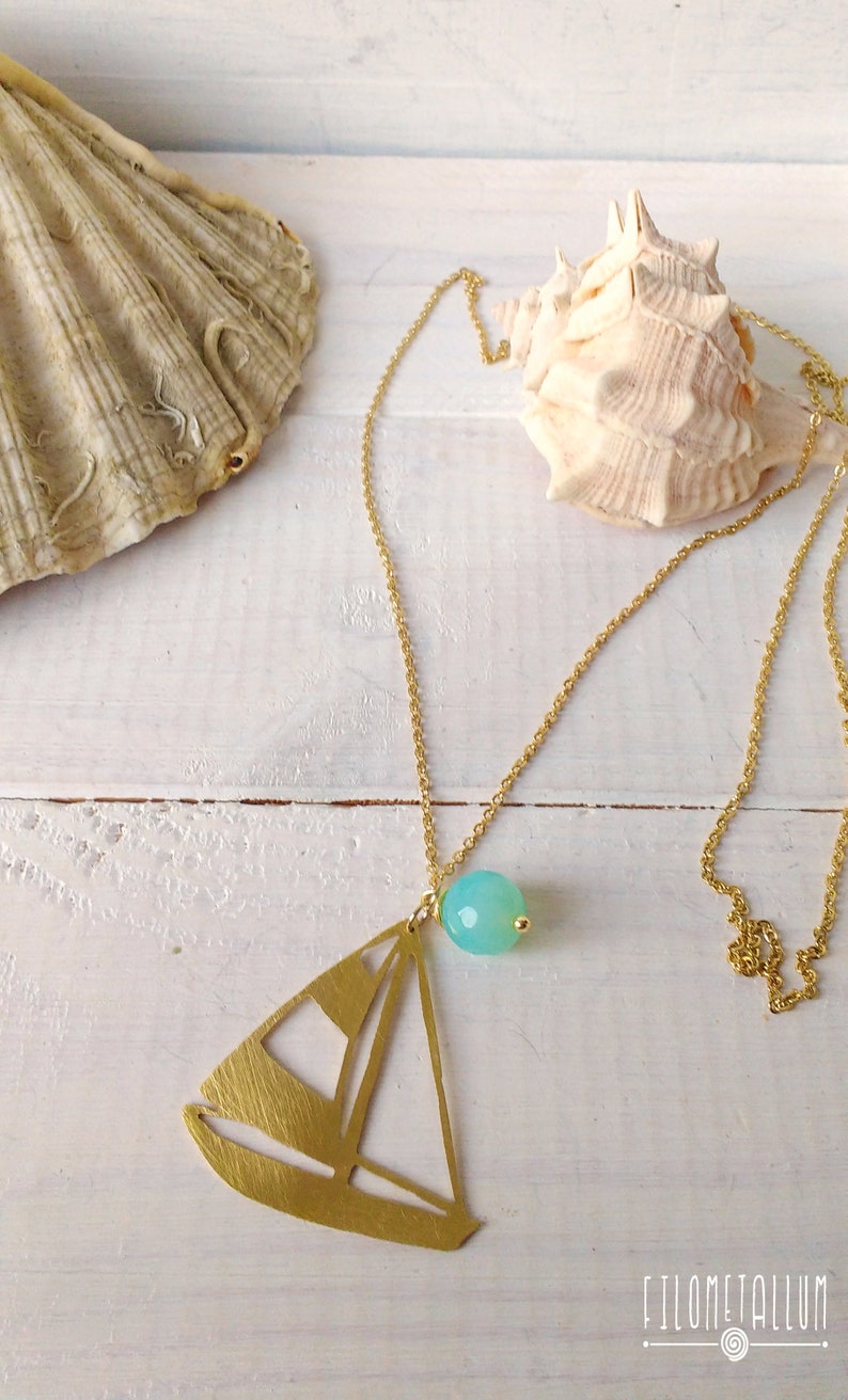 long necklace with steel chain and brass pendant in the shape of a sailboat handmade