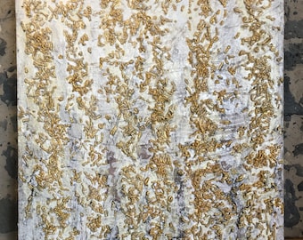 May include: Abstract painting with a white background and gold paint splatters. The gold paint is applied in a thick, textured layer, creating a three-dimensional effect.