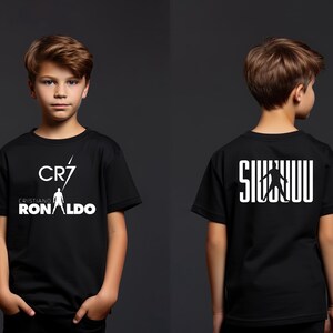 a young boy wearing a black shirt with white letters on it