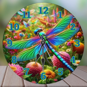 May include: A round wall clock featuring a vibrant dragonfly design. The clock face showcases a colorful dragonfly with blue, green, and purple wings, surrounded by flowers and other dragonflies. The numbers are in a bright blue font.