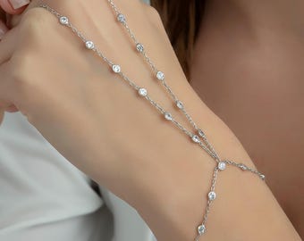 May include: A silver chain bracelet with small clear stones. The bracelet has a delicate design and is adjustable.