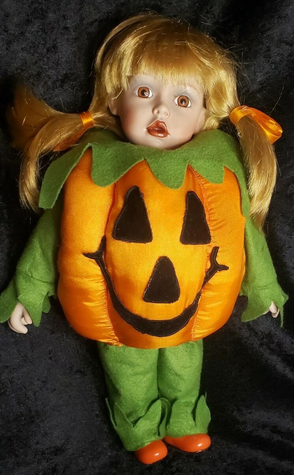 15.5" tall Porcelain doll in pumpkin Halloween costume. Very unique adorable D-8